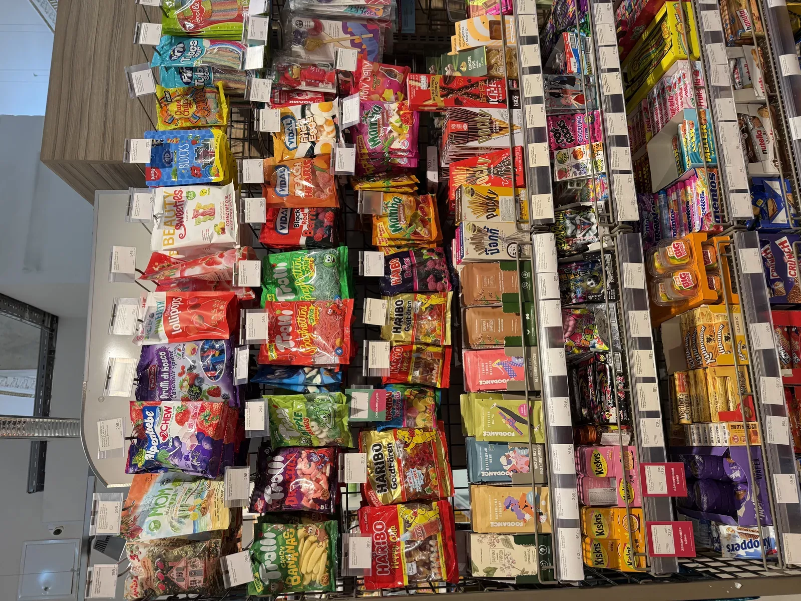 A retail candy shelf stocked with gummy and chew brands